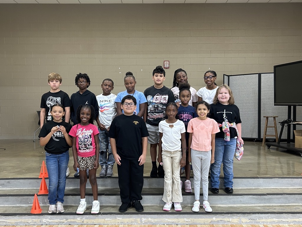 Group photo of McCalla Elementary fourth-grade students celebrating their success in meeting mCLASS and i-Ready benchmark goals.