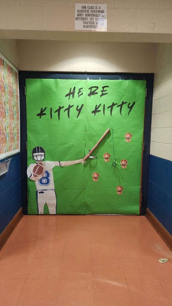 Ms. Bullard's Advisory class door decoration. A green background with words that say Here Kitty, Kitty. A football player is holding a ball and a fishing rod with small lions to catch.