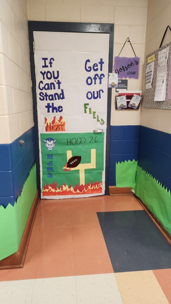 Mrs. Dotson's Advisory class door says If you can't Stand the Heat, get off our field. Hoco 26 NJMS. It has flames at the bottom, a goal post and a football with flames going through it.