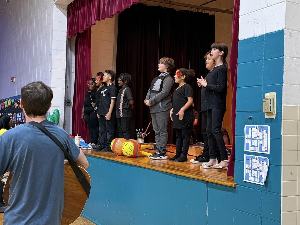 Students singing on stage. 