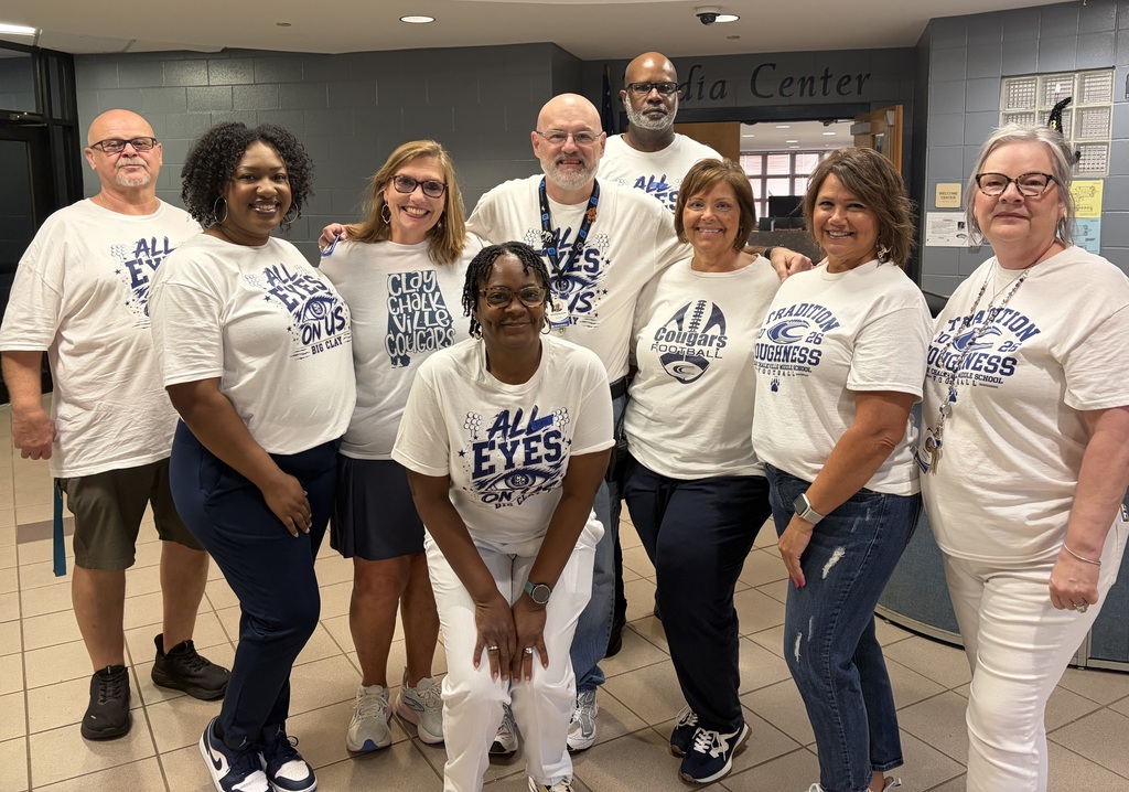 Group wearing jeans and white tees with all eyes on us in blue writing 