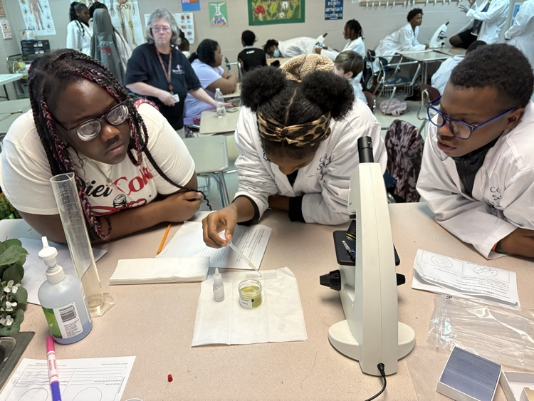 students wearing white lab coats