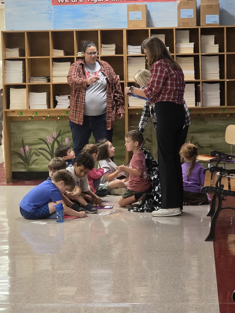 2 teachers leading a group of students in a game