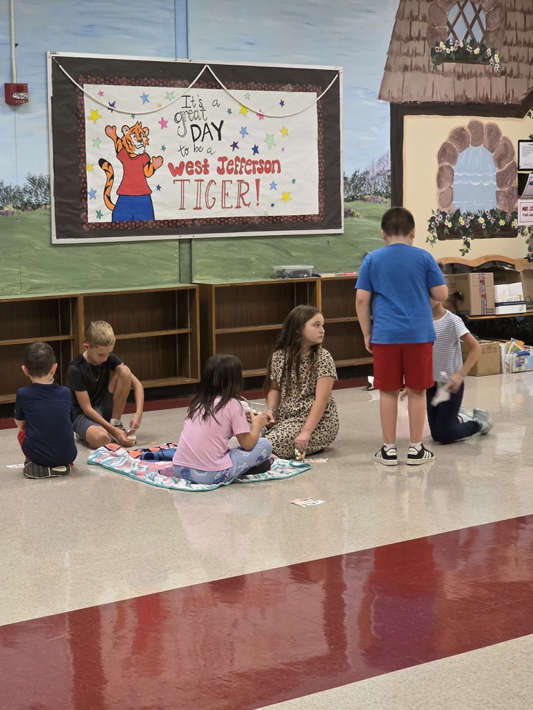 students sitting on the floor eating a snack