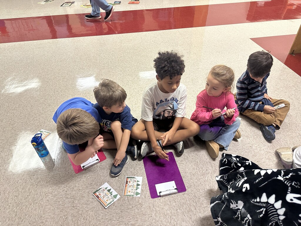 students sitting on the floor playing a game