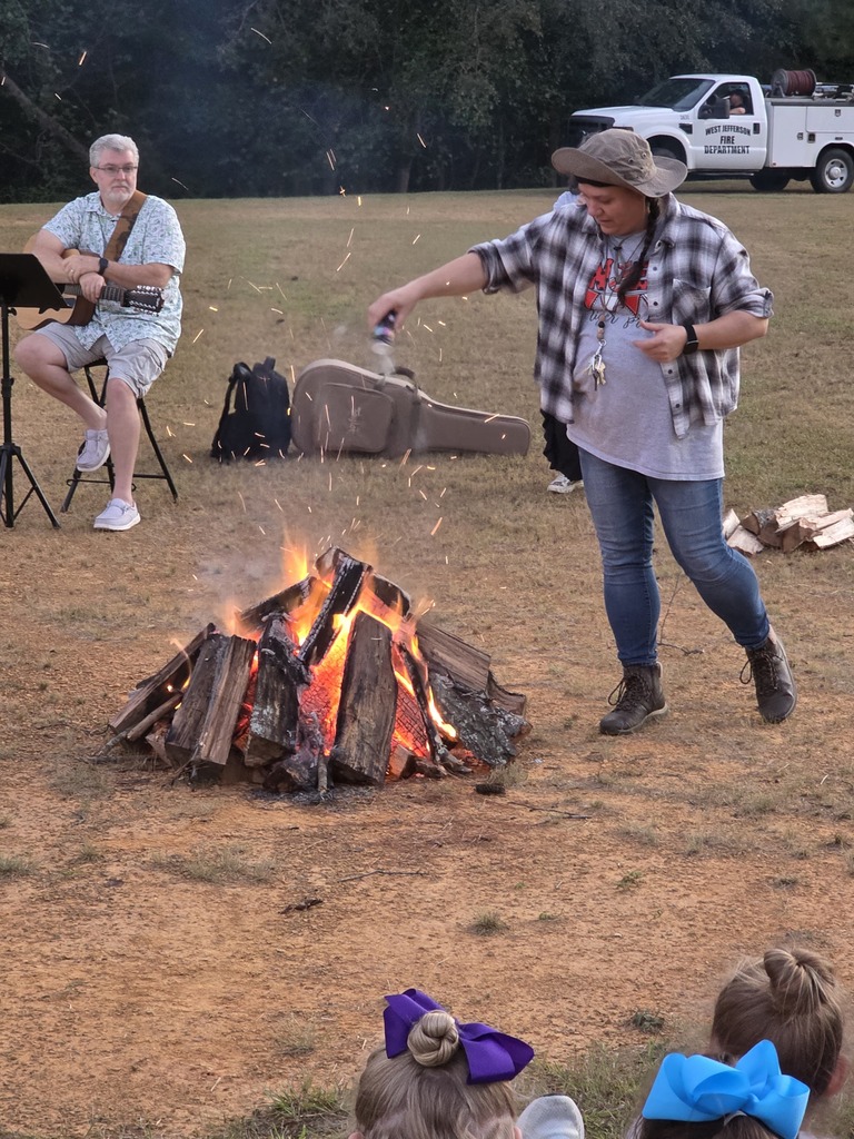 lady sprinkling minerals in a campfire