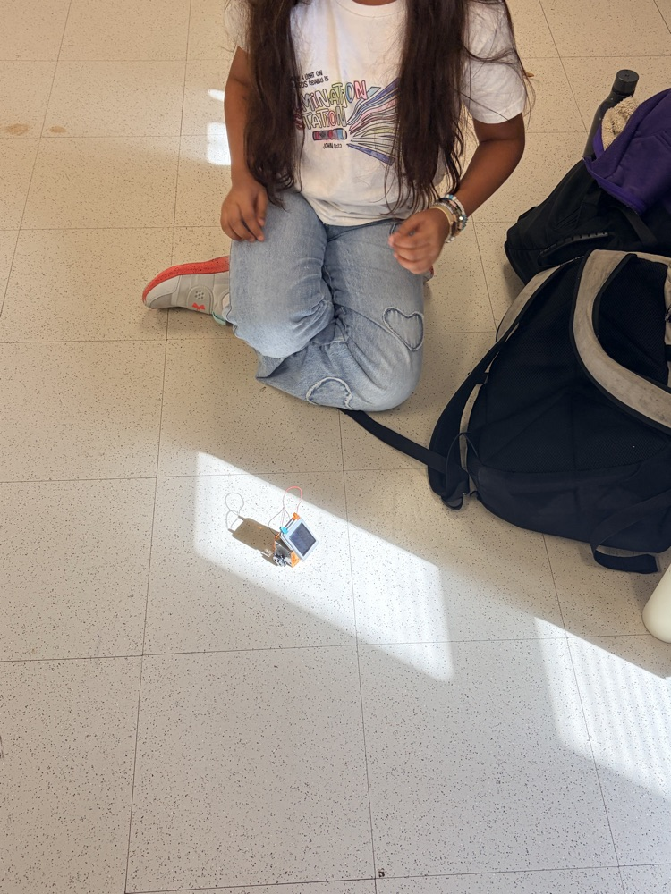solar powered robot with a girl kneeling 