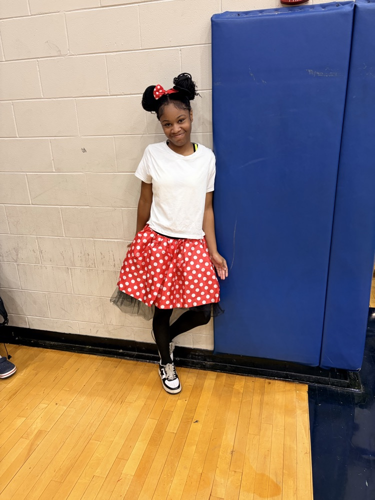Girl wearing Mickey Mouse ears and skirt