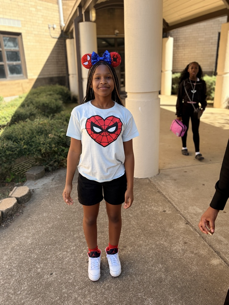 girl wearing Spider-Man shirt and ears