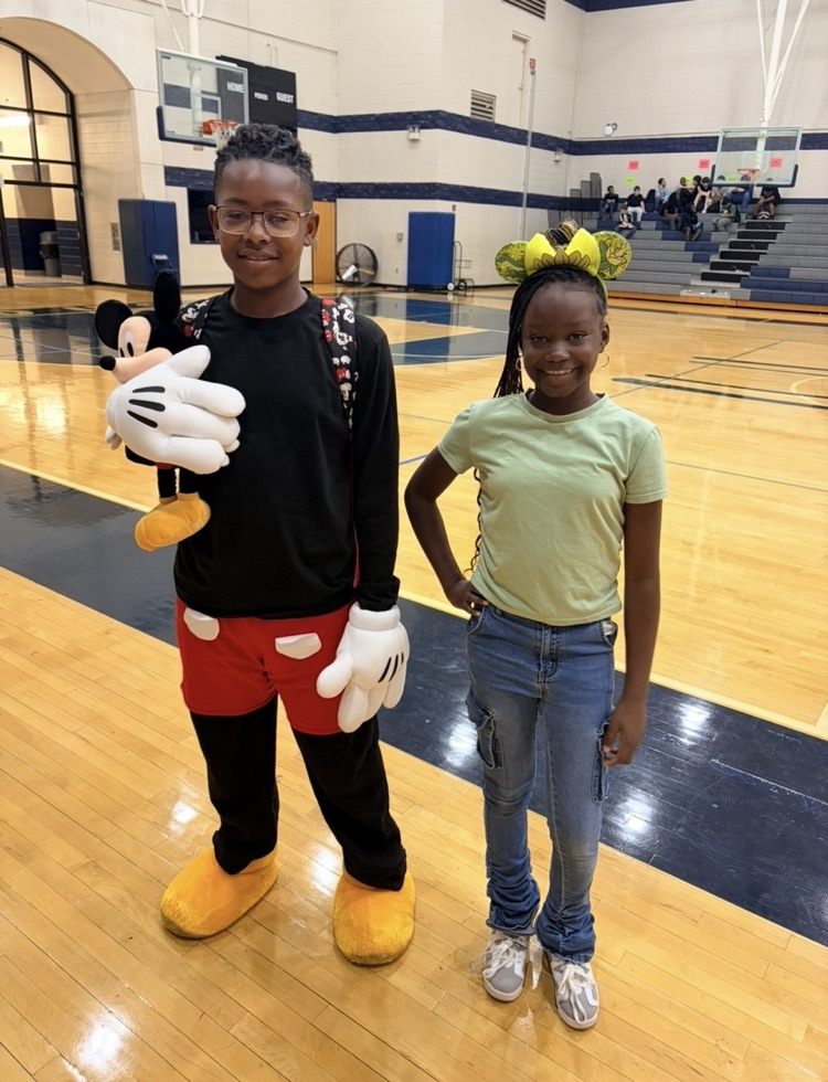 Boy dressed up as Mickey Mouse and girl dressed as Tiana