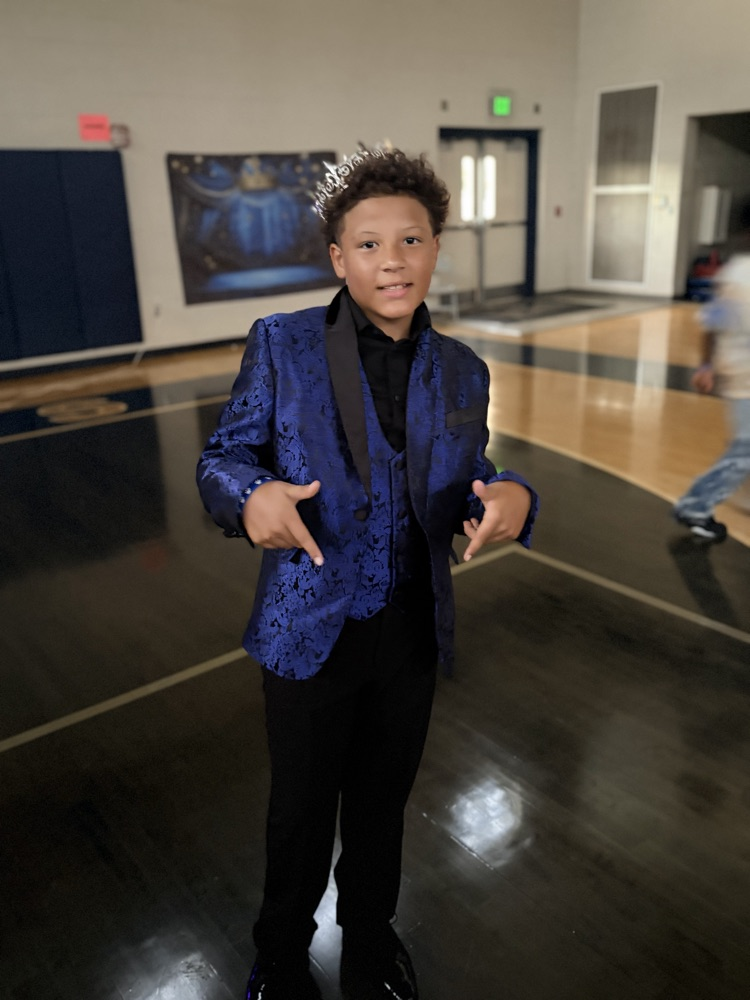 Boy wearing suit and crown