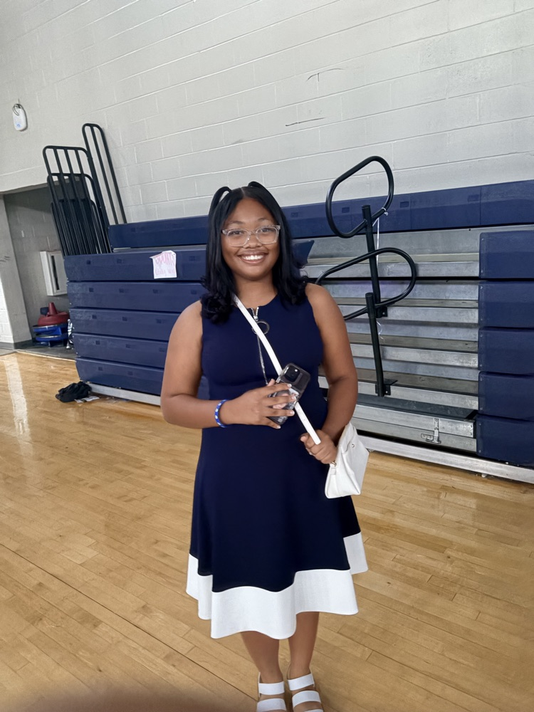 Girl wearing navy blue dress with white trim
