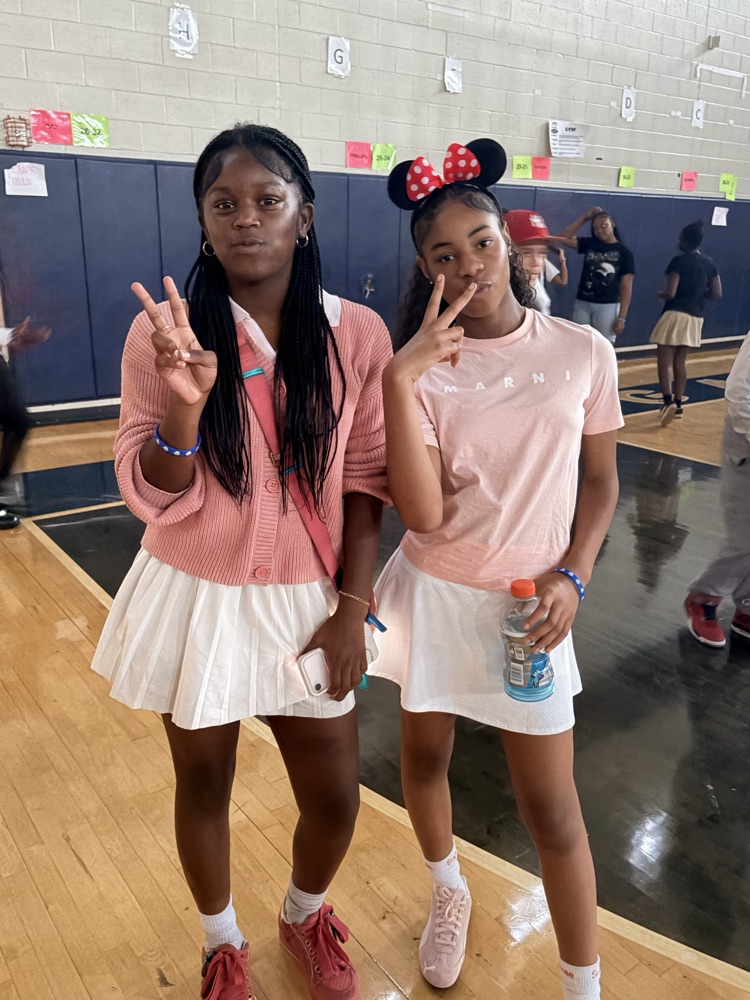 girls wearing skirts and pink shirts