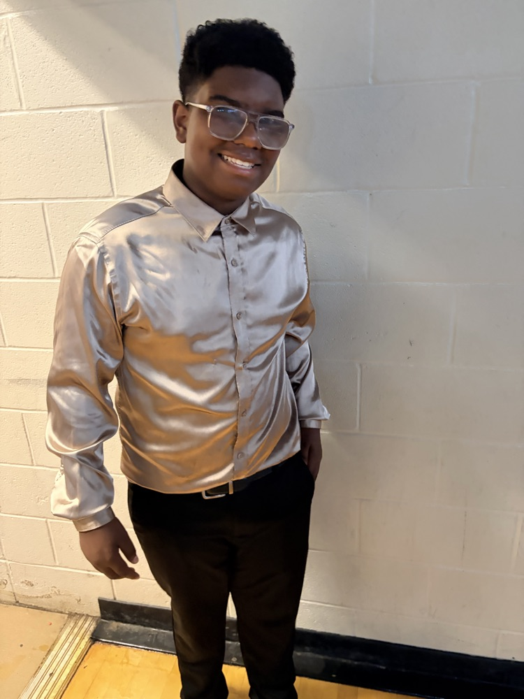 Boy wearing silk gold button down and black pants
