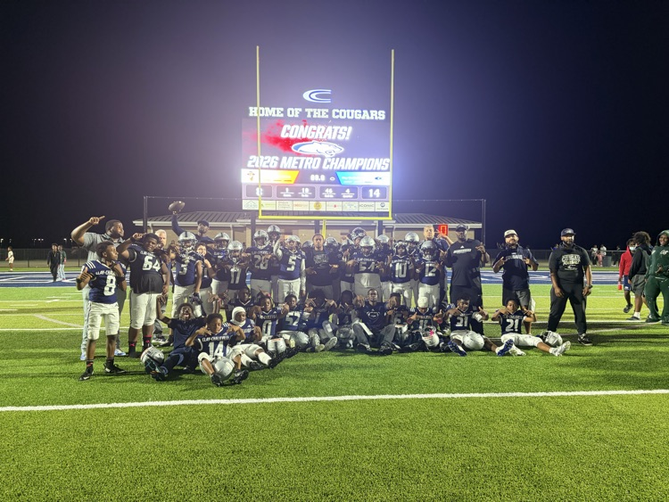 Football team and scoreboard in the back