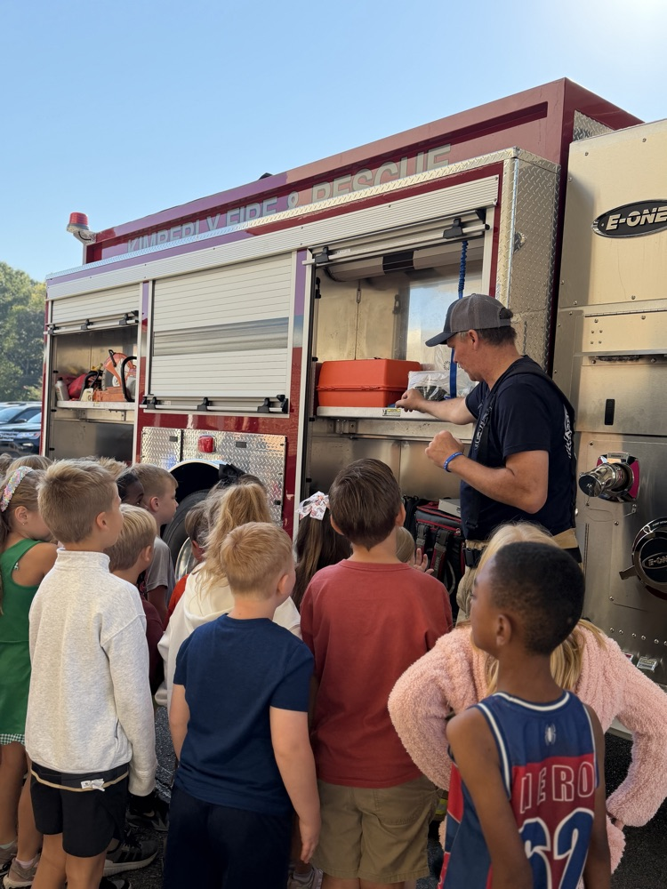 a fireman showing parts of the fire truck