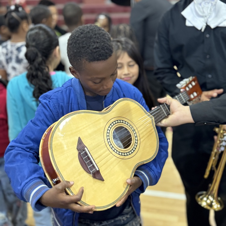 a student holding a stringed instrument