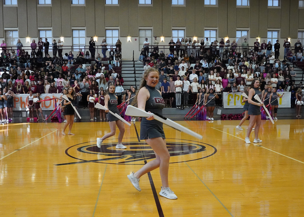 Gardendale High School rifle team members perform during a pep rally in the school gym.