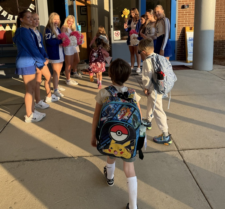 cheerleaders and dancers welcoming students into the school