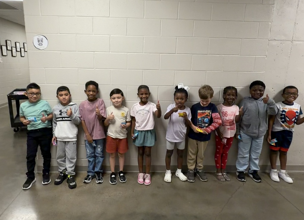 Group photo of McCalla Elementary first-grade students being recognized for meeting their mCLASS and i-Ready benchmark goals.