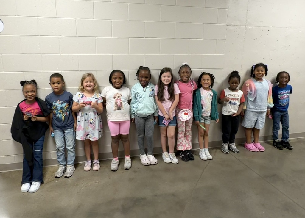 Group photo of McCalla Elementary first-grade students being recognized for meeting their mCLASS and i-Ready benchmark goals.