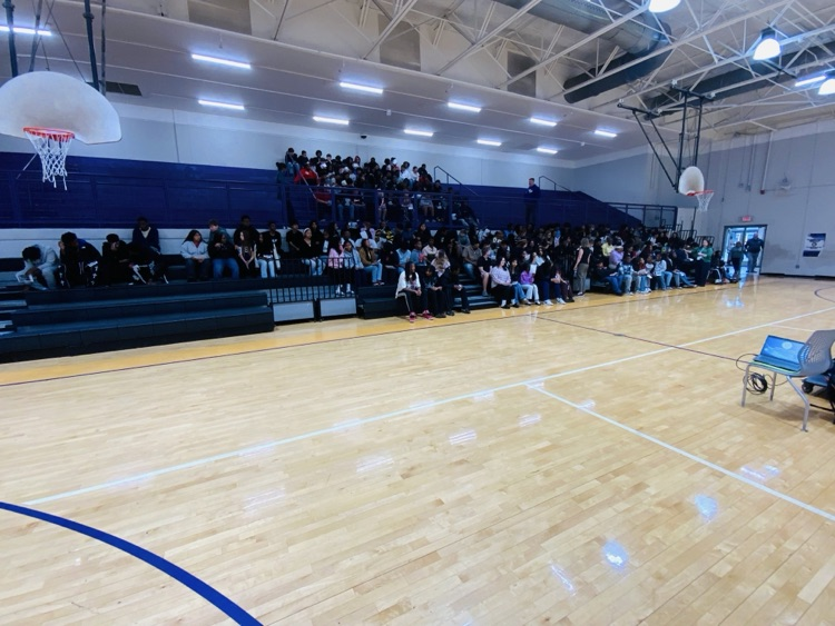 HMS eighth-grade students sit in the competition gym bleachers during the JCIB recruitment presentation.