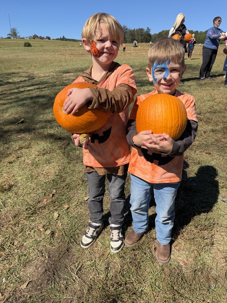 two students enjoying the pumpkin patch