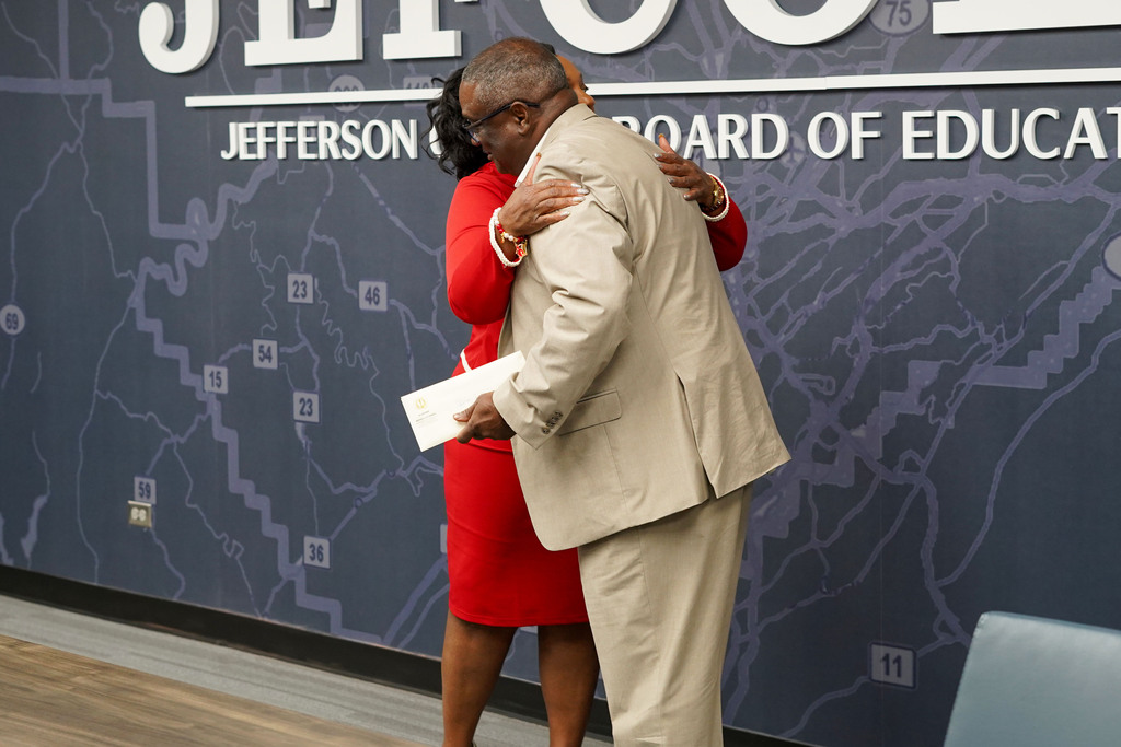 Senator Merika Coleman and Superintendent Dr. Walter Gonsoulin hug while standing in the JEFCOED conference room.