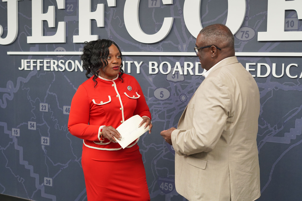 Senator Merika Coleman and Superintendent Dr. Walter Gonsoulin speak to each other while standing in the JEFCOED conference room.