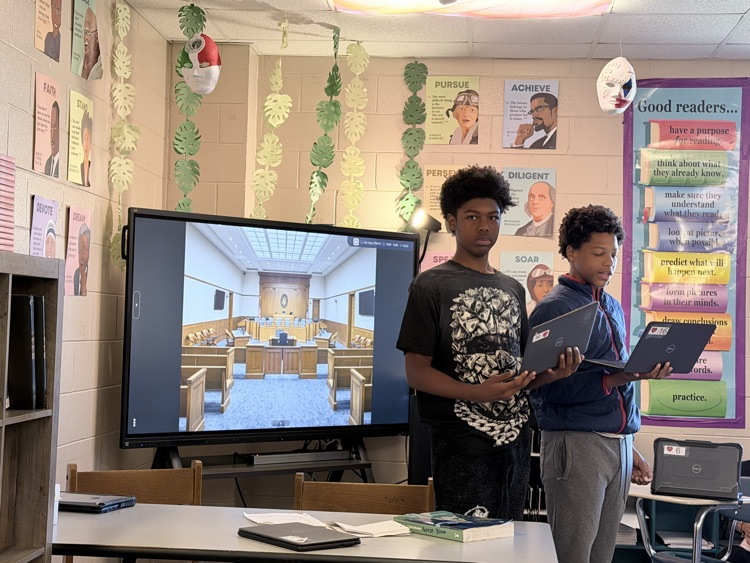 Students standing having a mock trial