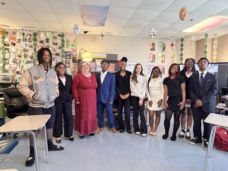 Students posing in a picture with a lawyer