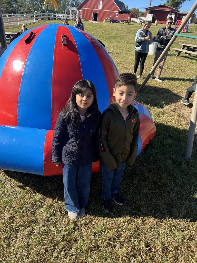 two kids at the pumpkin patch