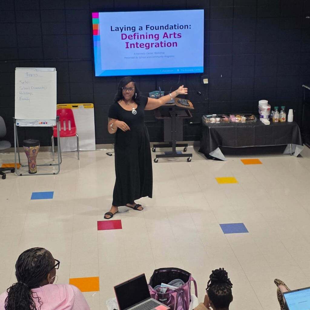 A woman leads a presentation in a classroom.