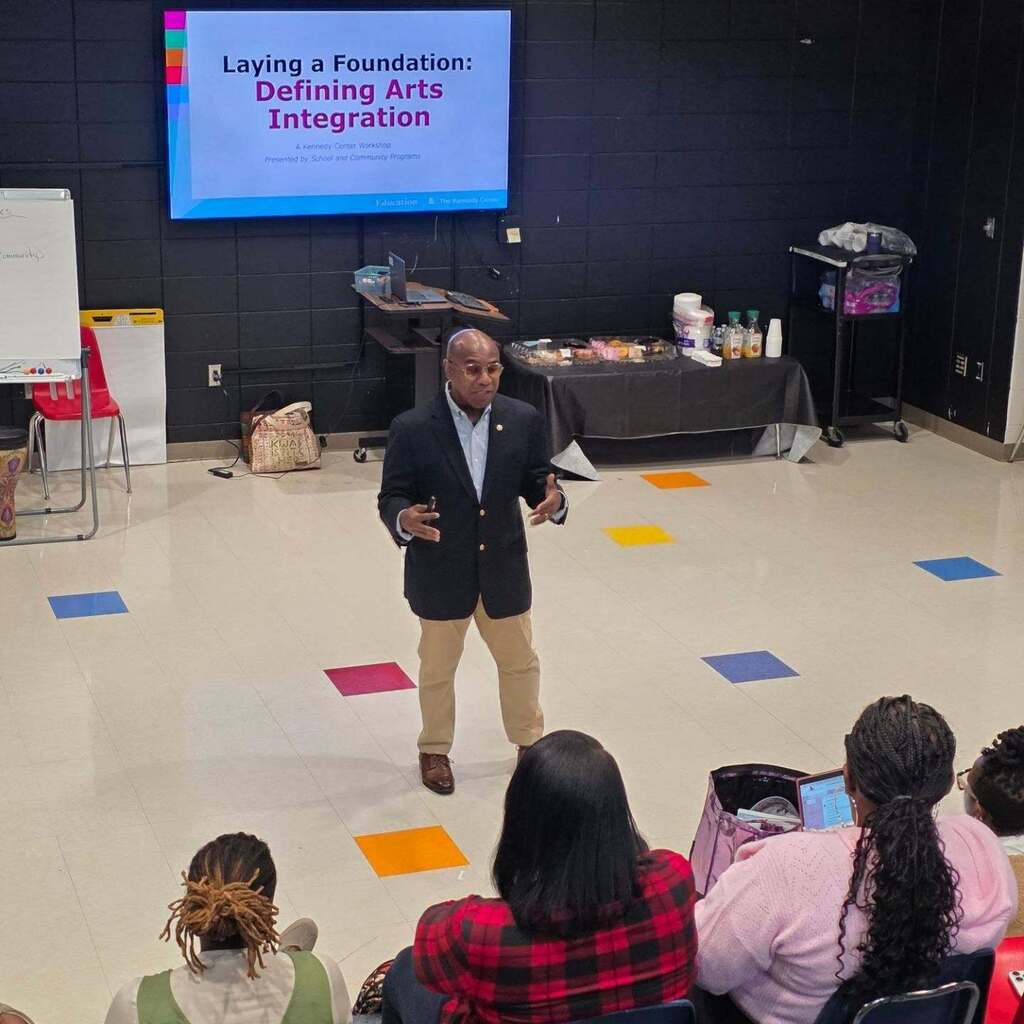 A man leads a presentation in a classroom.