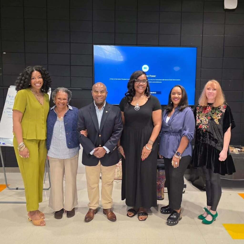 JEFCOED Arts employees and representatives from the John F. Kennedy Center for the Performing Arts stand together for a photo inside a classroom.