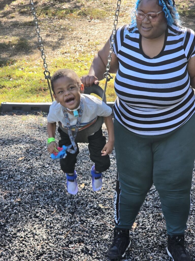 a student being pushed on a swing