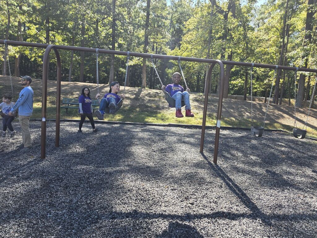 two students swinging at the park