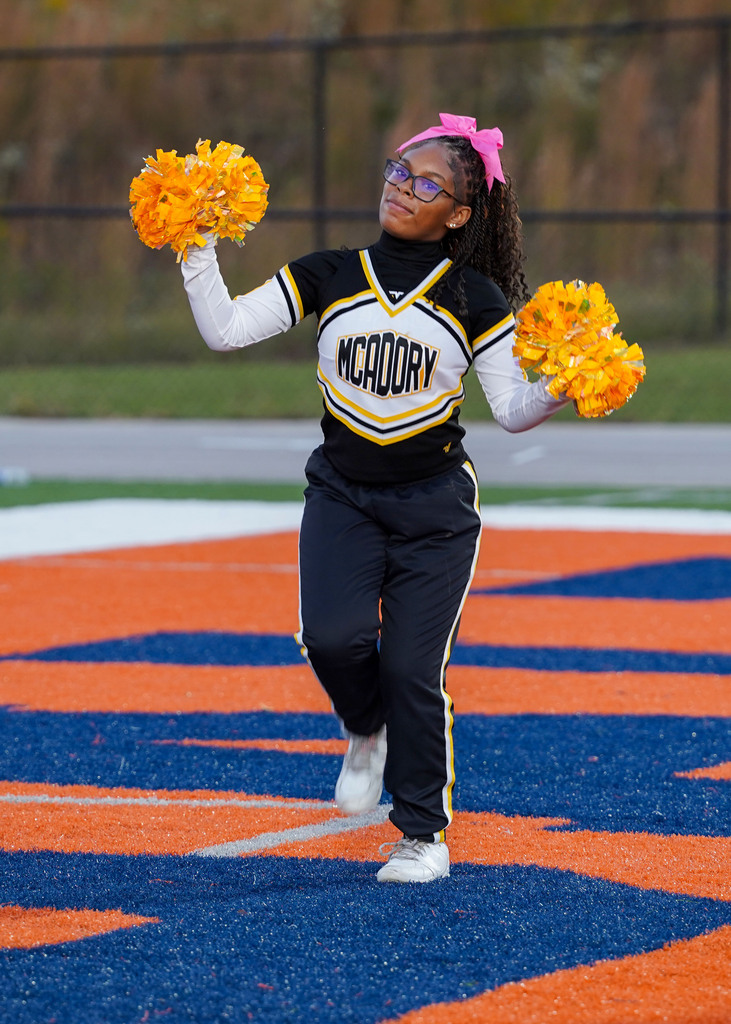 A McAdory Middle School cheerleader performs a cheer during a football game.