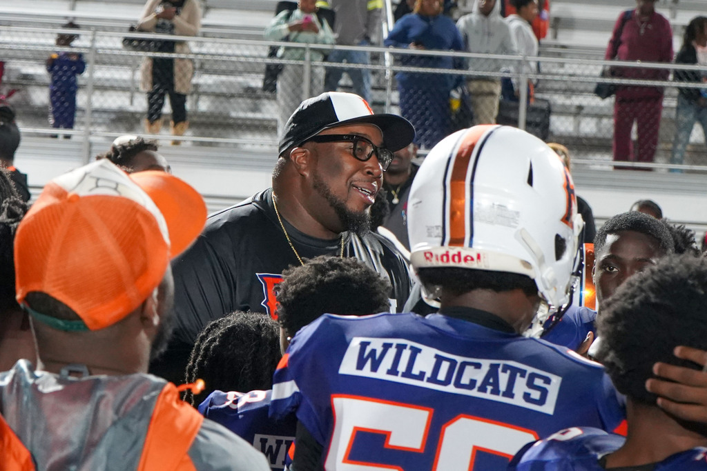 Fultondale's middle school football coach speaks to his players during a football game.