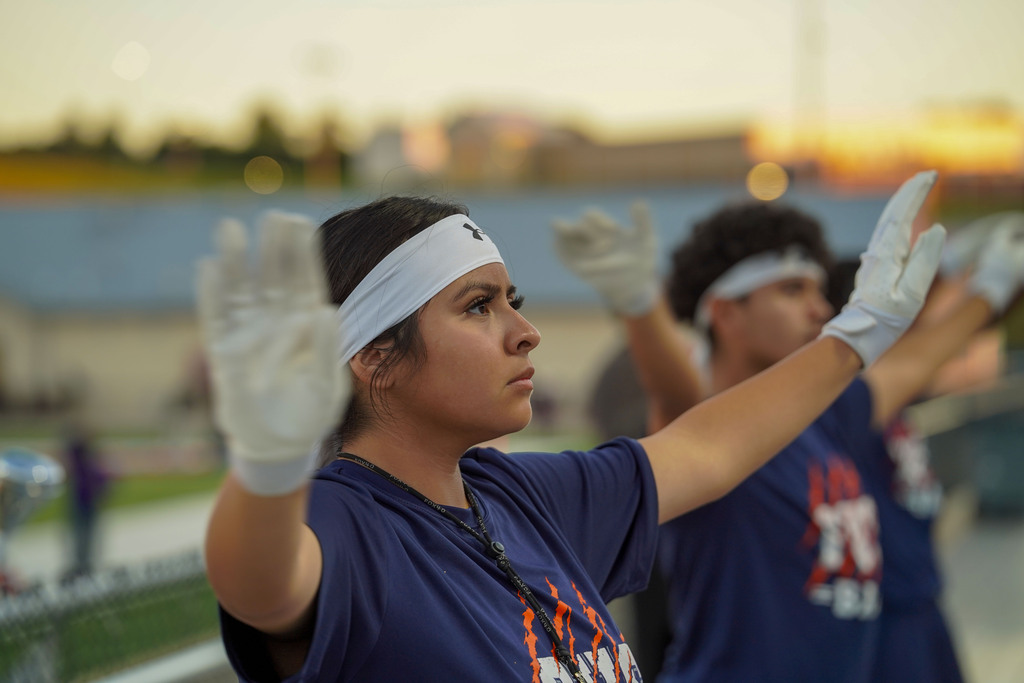 A Fultondale Drum Major conducts the band during a football game.