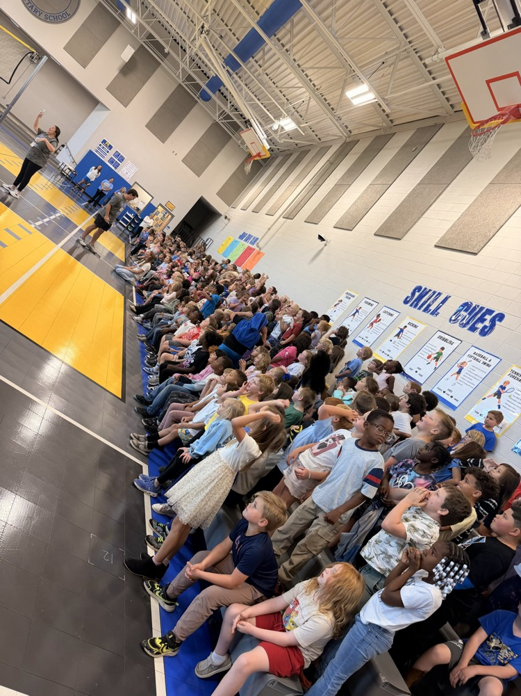 kindergarten through second grade students in the stands in the gym watching the newcomb game 