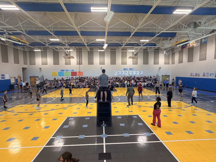 a picture of the newcomb court with parents playing on one side and the court and the girls team on the other 