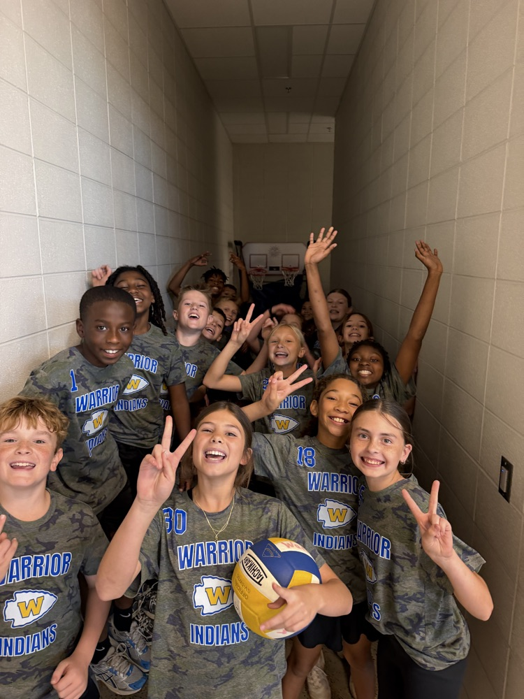 boys and girls newcomb team all posing together in the hallway 