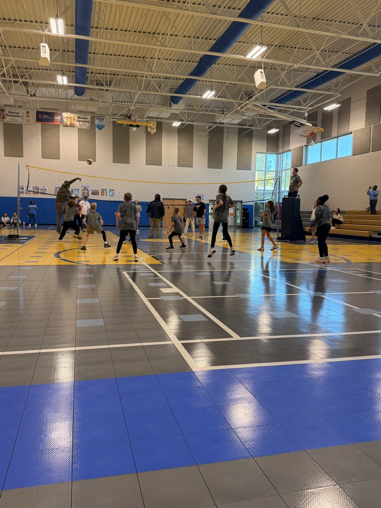 parents playing on one side of the new and the girls team playing on the other side 