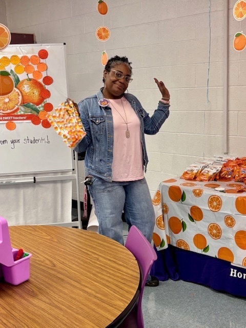 teacher smiling with goodie bag in hand