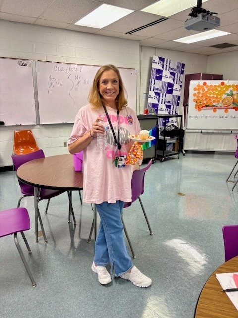 teacher smiling and holding snacks