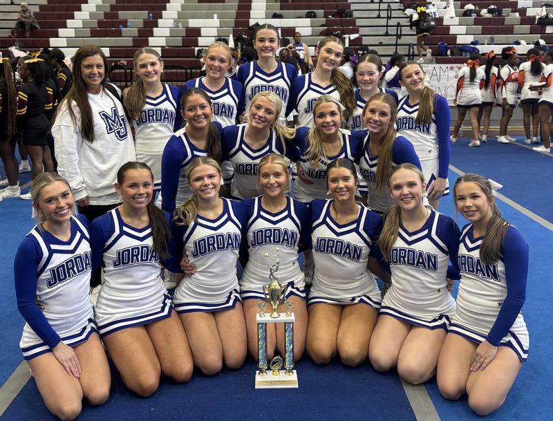 Mortimer Jordan High School cheerleaders pose with a trophy inside a school gym.