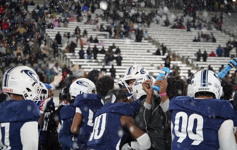 Clay-Chalkville football players spray water as they celebrate their State Championship football win at Protective Stadium.