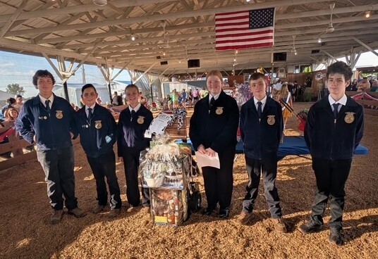FFA students standing with their auction item