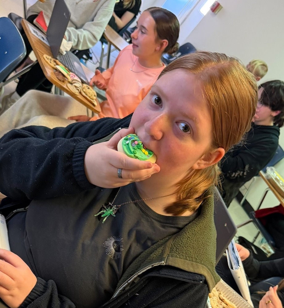 Student is taking a bite out of a cookie